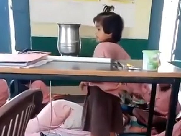 X Screengrab : Teacher sleeping in class in UP as students fan her